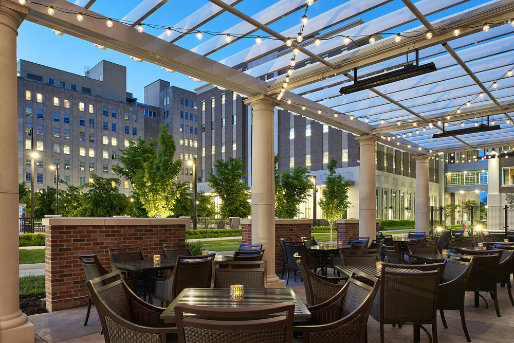 outdoor dining patio with string lights on pergola