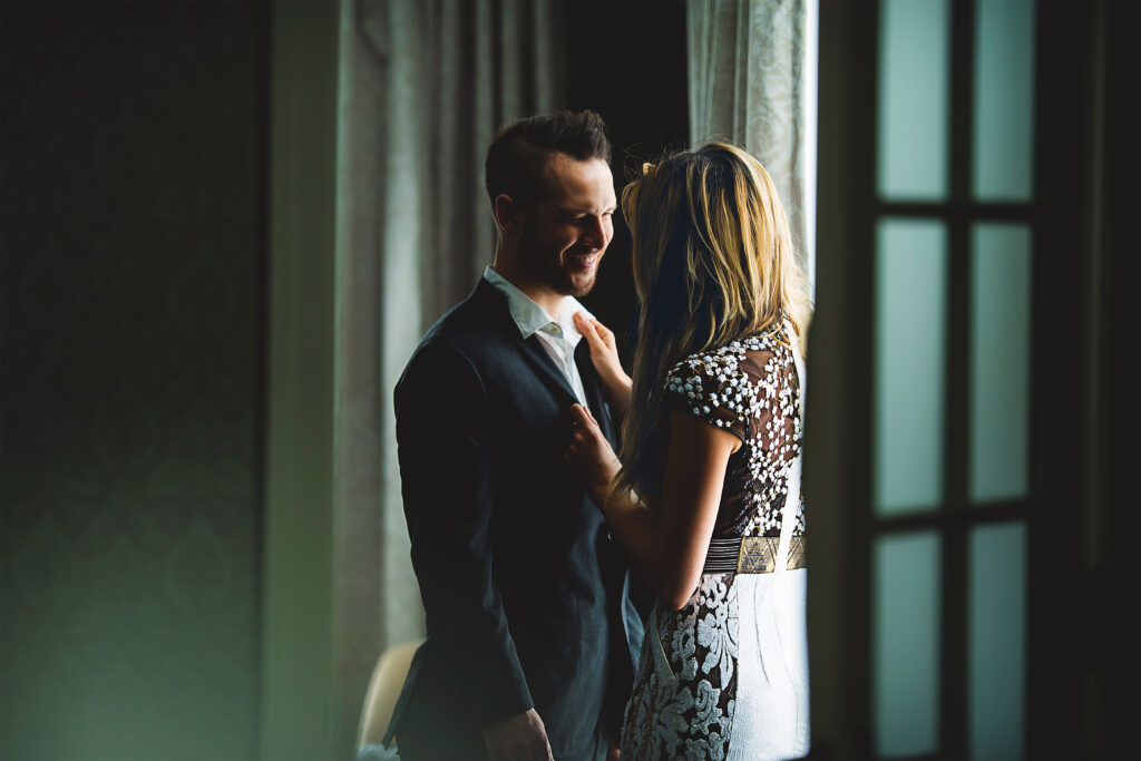 Hancock_Lifestyle_Suite couple in a hotel embracing romantically by a window