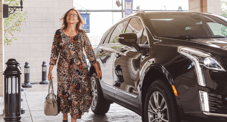 woman exiting vehicle in valet lane at hotel to check in