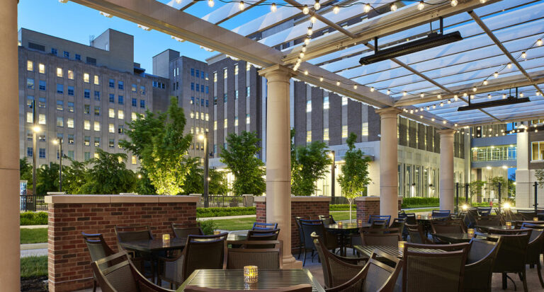 outdoor dining patio with string lights on pergola